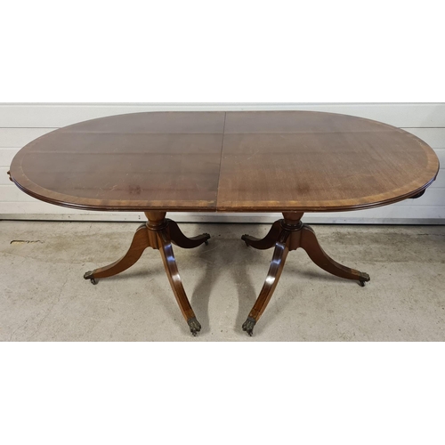 1465 - A large reproduction dark wood, oval shaped, extending dining table with brass inlaid detail. Turned... 