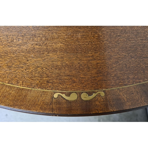 1465 - A large reproduction dark wood, oval shaped, extending dining table with brass inlaid detail. Turned... 