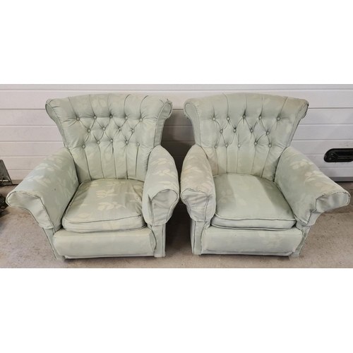 1470 - A pair of 1930's curve backed low armchairs on caster feet. Reupholstered with green foliate designe... 