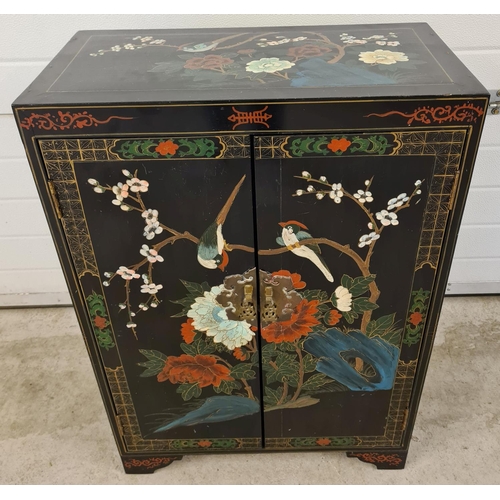 1472 - A vintage Chinese black lacquer 2 door cupboard with hand painted floral & bird detail. With decorat... 