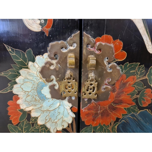 1472 - A vintage Chinese black lacquer 2 door cupboard with hand painted floral & bird detail. With decorat... 