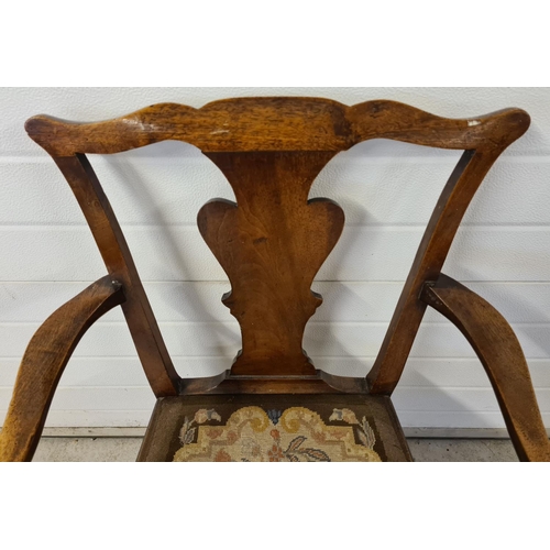 1475 - A Georgian walnut carver armchair with square legs, shaped back & back panel and needlepoint upholst... 