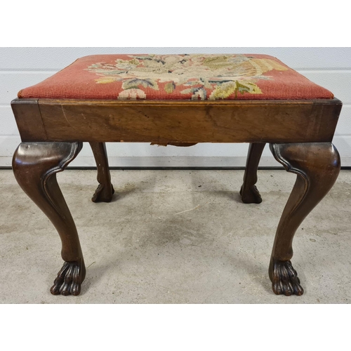 1476 - A Georgian walnut claw foot stool with chunky cabriole shaped legs. Approx. 47cm tall x 60cm wide.