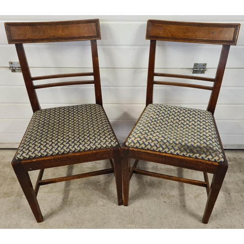 1477 - A pair of Georgian walnut curved back dining chairs with channelled detail and square legs. With geo... 