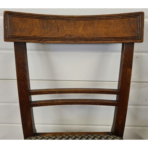 1477 - A pair of Georgian walnut curved back dining chairs with channelled detail and square legs. With geo... 