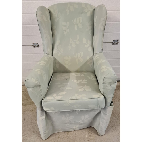 1480 - A vintage wooden framed wing back armchair, reupholstered with green foliate design material.