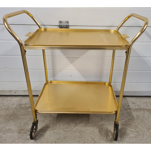 1364 - A retro gold coloured aluminium 2 tier tea trolley with removable tray/top tier. With large black ru... 