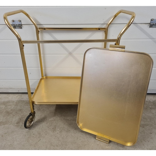 1364 - A retro gold coloured aluminium 2 tier tea trolley with removable tray/top tier. With large black ru... 