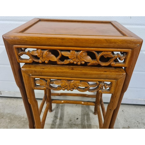 1485 - 2 Oriental nesting tables with shaped legs and carved pierced work detail of grape vine design. Larg... 