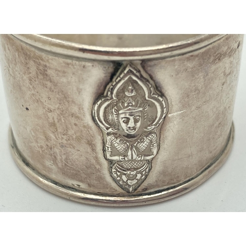 1199 - A set of 4 Thai silver napkin rings with Thai deity decoration to front. Each napkin marked 