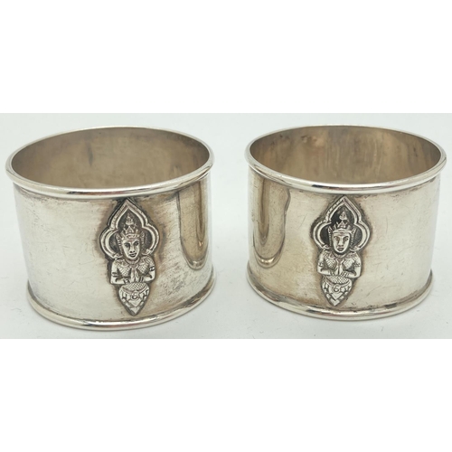 1201 - A pair of vintage sterling silver napkin rings with oriental deity decoration to front and back. Mar... 