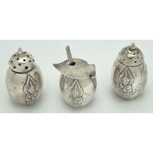 1202 - A vintage sterling silver cruet set with oriental deity decoration front and back. Comprising: salt ... 