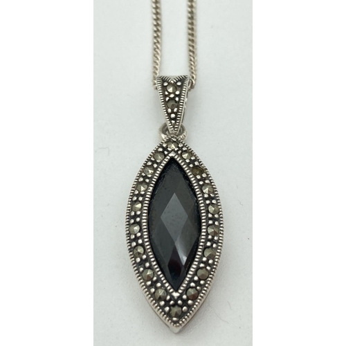 1065 - A modern design marquise shaped silver pendant set with faceted black onyx and marcasite stones. Mar... 