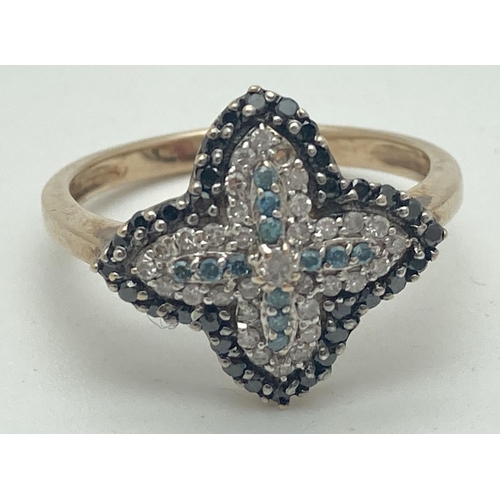 1001 - A 9ct gold flower design diamond cluster ring set with clear, black and blue diamonds. One small cle... 