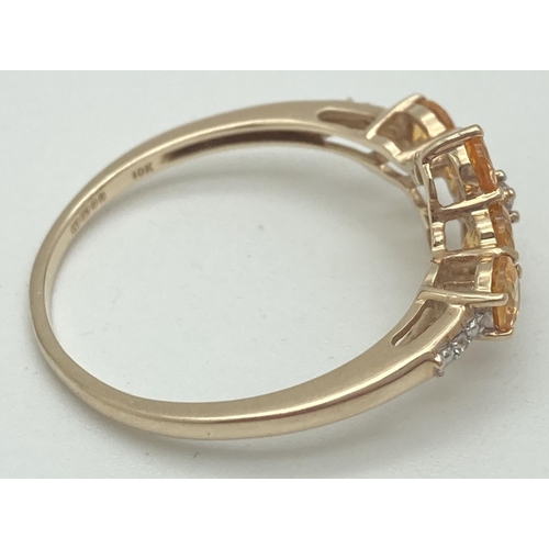 1068 - A 9ct gold citrine and diamond set dress ring by The Genuine Gem Company. 6 round cut citrine stones... 