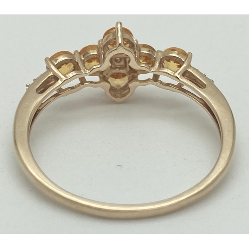 1068 - A 9ct gold citrine and diamond set dress ring by The Genuine Gem Company. 6 round cut citrine stones... 