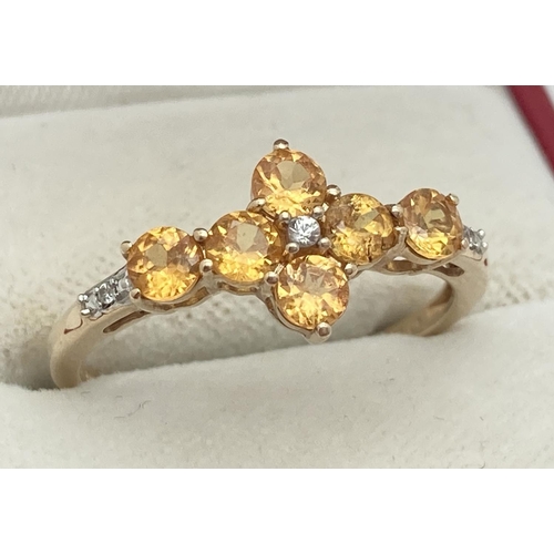 1068 - A 9ct gold citrine and diamond set dress ring by The Genuine Gem Company. 6 round cut citrine stones... 