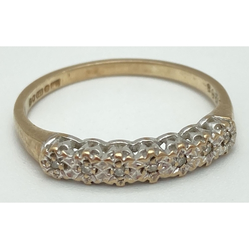 1070 - A 9ct gold and diamond half eternity ring with 7 illusion set stones. Fully hallmarked inside band, ... 