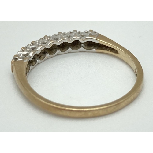 1070 - A 9ct gold and diamond half eternity ring with 7 illusion set stones. Fully hallmarked inside band, ... 