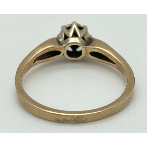 1071 - A 9ct yellow gold illusion set diamond solitaire ring with open shoulders. Fully hallmarked inside b... 