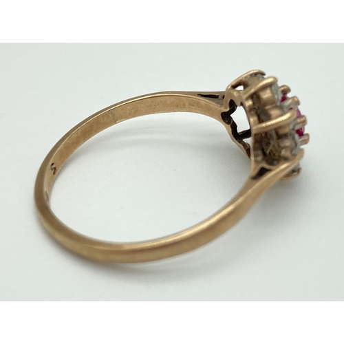 1072 - A 9ct gold flower cluster ring set with central pink ruby surrounded by 8 colourless spinel stones. ... 