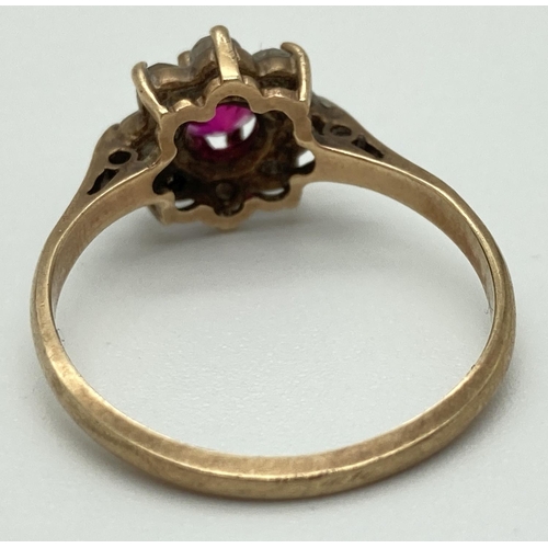 1072 - A 9ct gold flower cluster ring set with central pink ruby surrounded by 8 colourless spinel stones. ... 