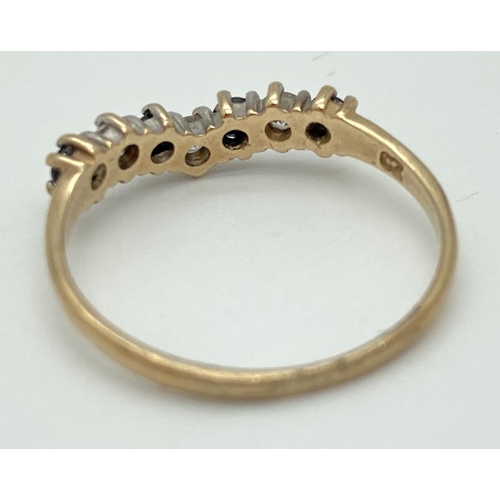 1073 - A 9ct gold, sapphire and cubic zirconia half eternity wishbone ring. Ring size N, total weight appro... 