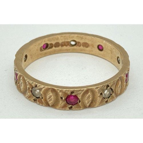 1075 - A fully hallmarked vintage 9ct gold full eternity ring set with rubies and clear stones. With engrav... 