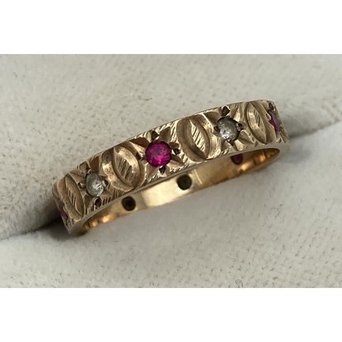 1075 - A fully hallmarked vintage 9ct gold full eternity ring set with rubies and clear stones. With engrav... 