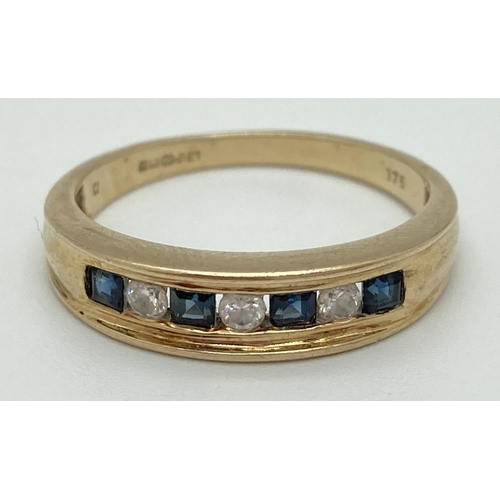 1076 - A 9ct yellow gold ring with channel set square cut sapphires and round cut cubic zirconia's. Fully h... 