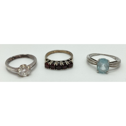 1077 - 3 925 silver stone set rings, all stamped inside of bands. A cubic zirconia solitaire ring (size L),... 