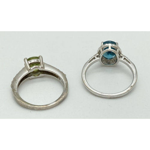 1085 - 2 coloured and clear stone set 925 silver rings. A Genuine Gem Company peridot ring set with 5 clear... 