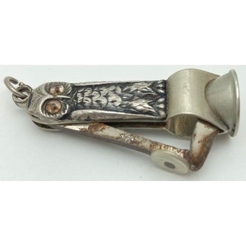 1207 - An antique white metal novelty cigar cutter in the form of an owl. With glass eyes and hanging bale.... 