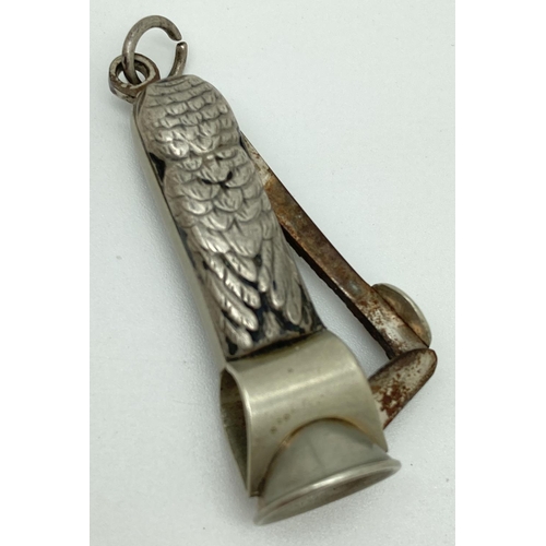 1207 - An antique white metal novelty cigar cutter in the form of an owl. With glass eyes and hanging bale.... 