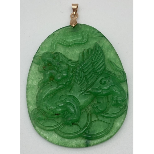 1305 - A carved jade pendant, with yellow metal bale, designed with Chinese dragon carving to one side. App... 