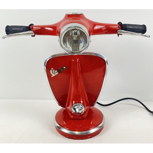 1430 - A novelty table lamp in the shape of the handlebars of a Vespa scooter, painted red. With moving bra... 