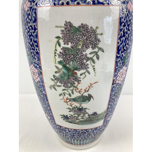 1307 - A finely painted large blue ground Chinese floor vase. With 4 panelled design featuring Chinese bird... 