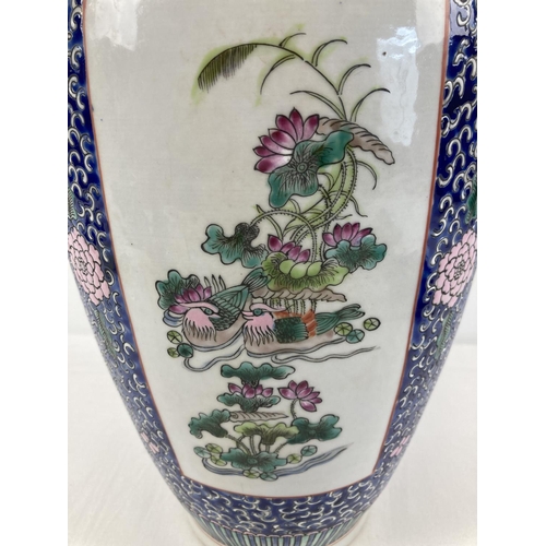 1307 - A finely painted large blue ground Chinese floor vase. With 4 panelled design featuring Chinese bird... 