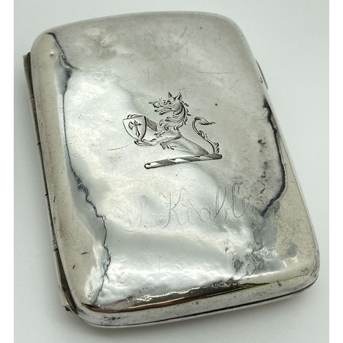 1214 - A Victorian silver curve backed cigarette case with engraved emblem to front. Hallmarked to both sid... 