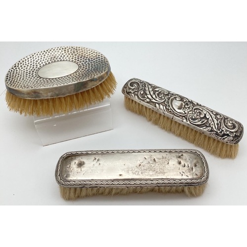 1215 - 3 Victorian & Edwardian silver backed dressing table brushes. An oval shaped curved back brush with ... 