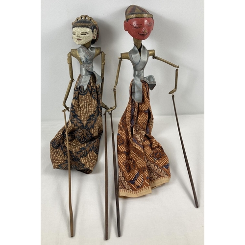 1375 - A pair of Burmese wooden rod puppets in traditional costume, with hand painted faces. Approx. 53cm l... 