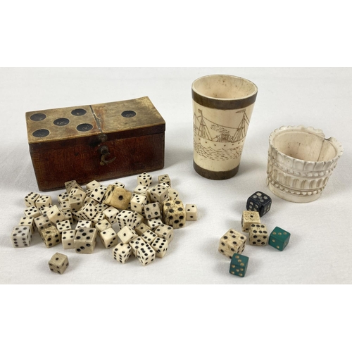 1378 - A vintage dice box containing miniature dice together with a Scrimshaw style vintage dice shaker wit... 