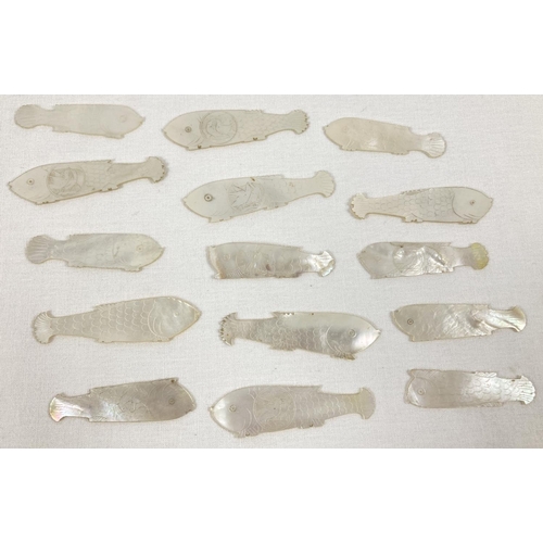 1381 - 15 antique carved mother of pearl gaming counters in the shape of fish. Many decorated with sea bird... 