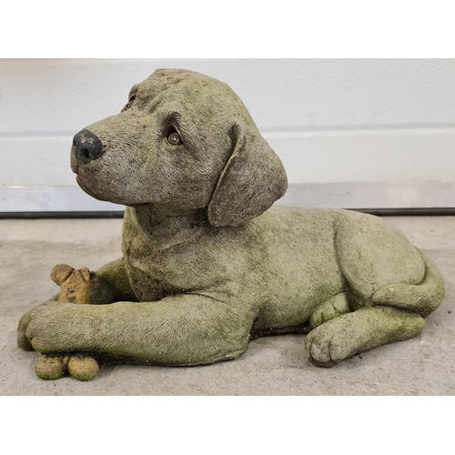 1422 - A modern concrete garden ornament of a puppy with a bone. Approx. 41cm long.