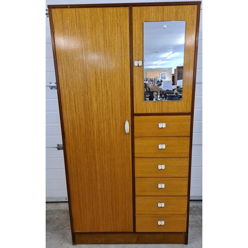 1490 - A mid century solid wood gentleman's wardrobe in light & medium wood finish. With period metal handl... 