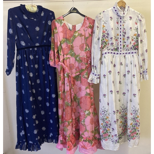 226 - 3 1970's womens long dresses all in floral patterns. Comprising: Blue floral by Angela Gore, London,... 