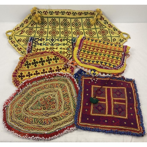 251 - A collection of vintage Central Asian heavily beaded and embroidered fabric panels. In varying sizes... 