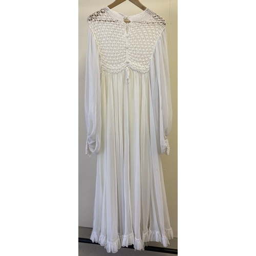 260 - A vintage 1970's white chiffon and crochet maxi dress with balloon sleeves and crocheted cuffs.