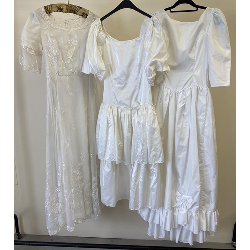 282 - 3 vintage 1980's short sleeved wedding dresses. A drop waist dress with frill and bow detail, a 2 ti... 