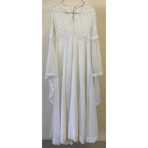 300 - A chiffon & lace 1970's long angel sleeved wedding dress. With lace detail to hems and bodice front ... 